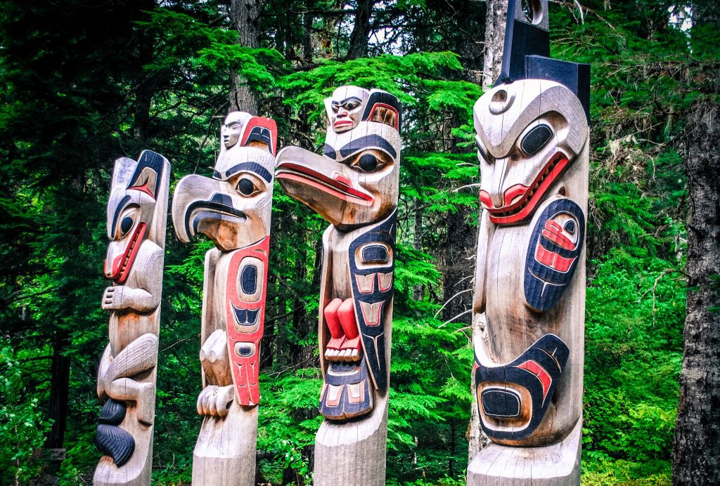 A row of four totem poles