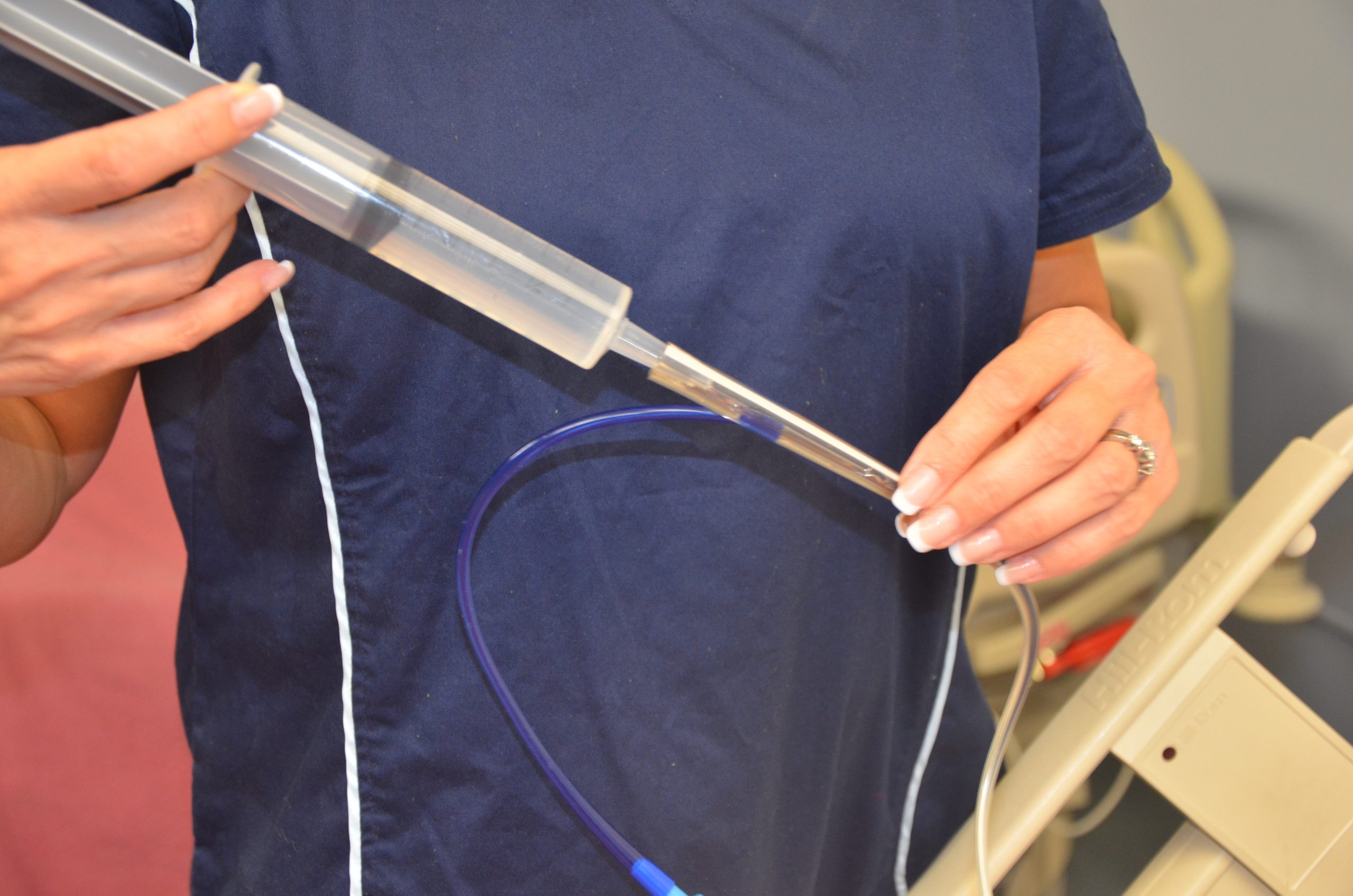 Photo of nursing Administering Medication via a Gastric Tube