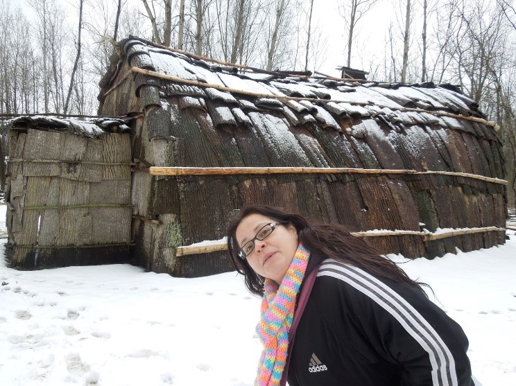 Jaimie in front of the Nmaachihna Enviro-education Centre.