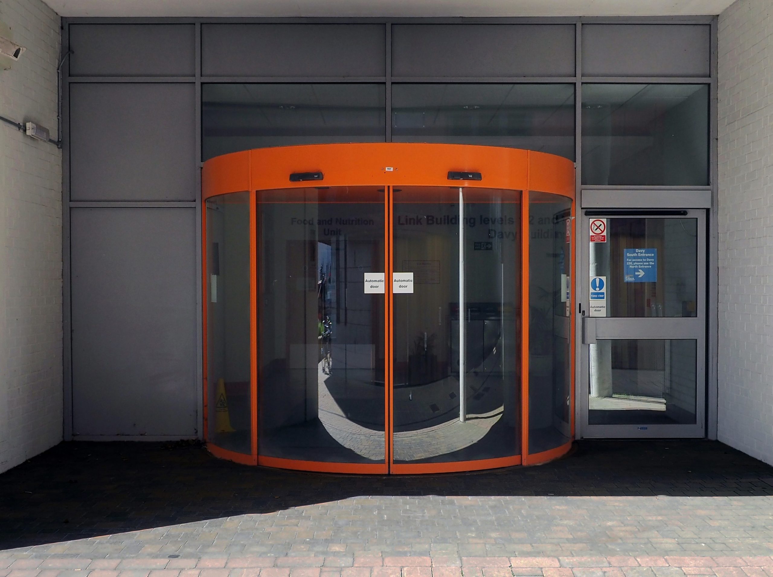 Accessible entrance to a building at ground level with automatic doors.