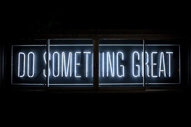 Neon sign saying “do something great”
