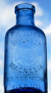 Photo showing empty Milk of Magnesia bottle