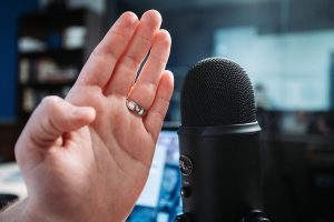 hand in front of microphone