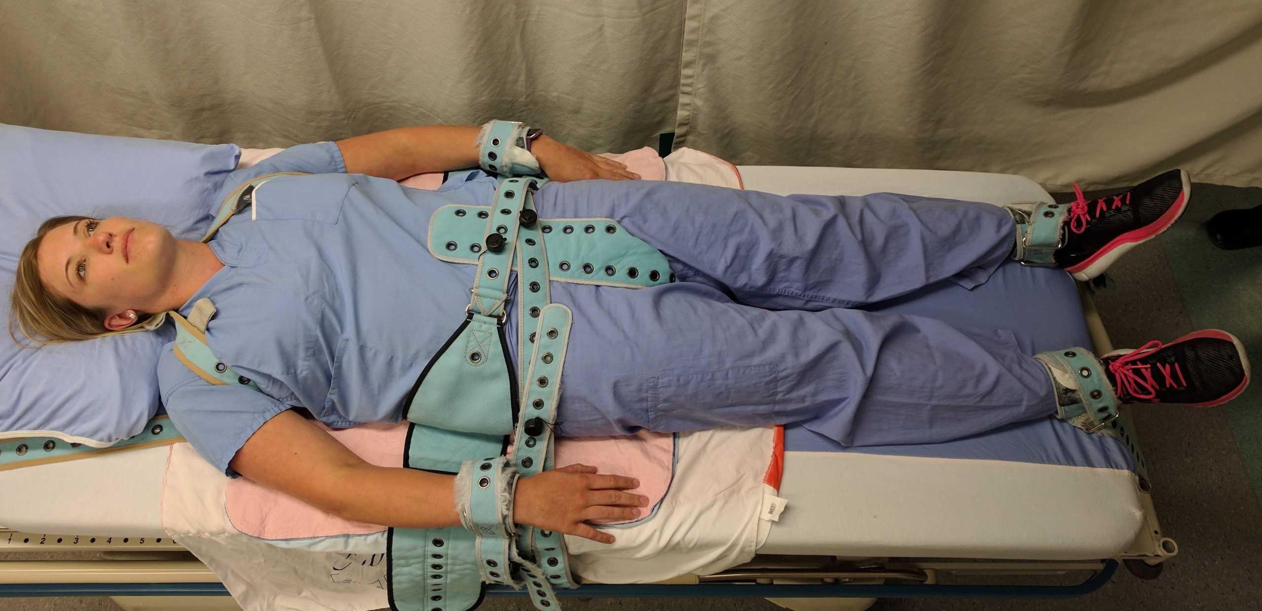 Photo showing a simulated patient in Full Physical Medical Restraints