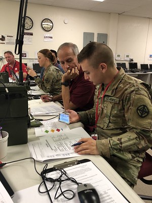 Military personnel using a smartphone.