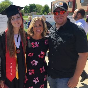 A photo of a family at a student graduation