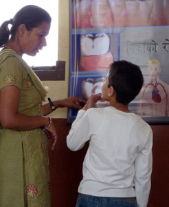 An adult female talking with a young boy